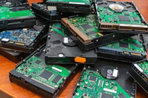 A pile of broken and obsolete hard drives for disposal and recycling